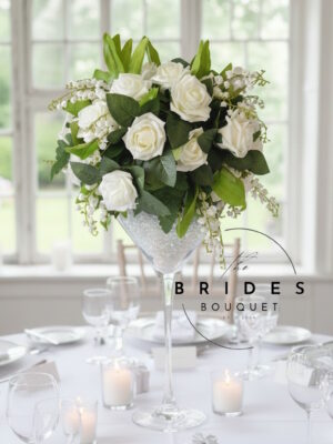 Martini glass wedding flower arrangement with artificial roses in wedding colour