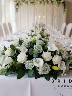 top table wedding flowers with roses calla lily and astilbe arrangement