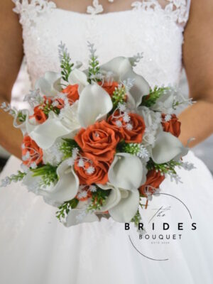 Artificial wedding bouquet with orange and white roses, calla lilies, gypsophila, and astilbe
