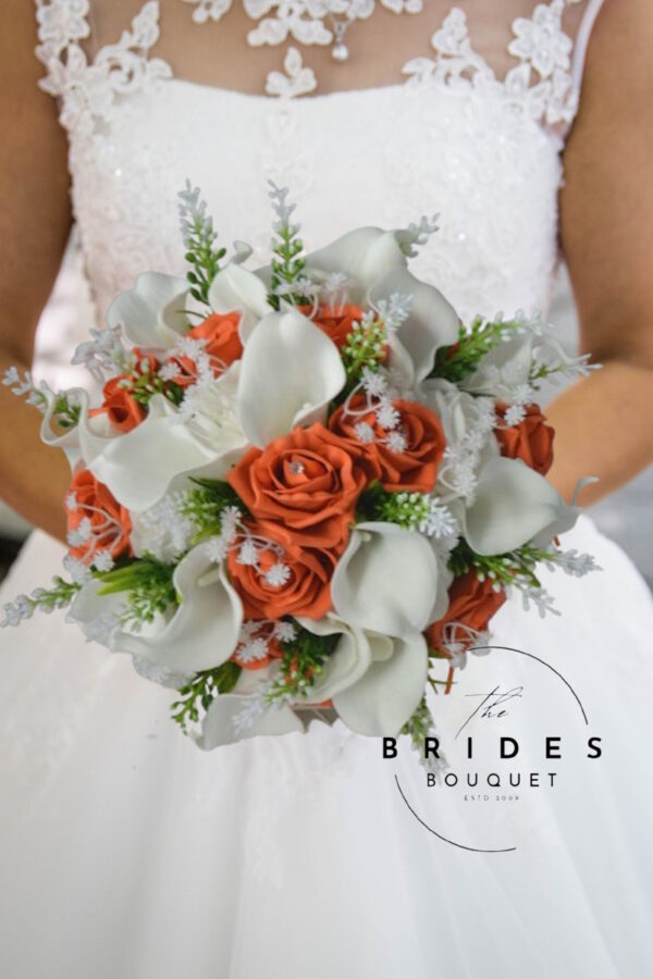 Artificial wedding bouquet with orange and white roses, calla lilies, gypsophila, and astilbe