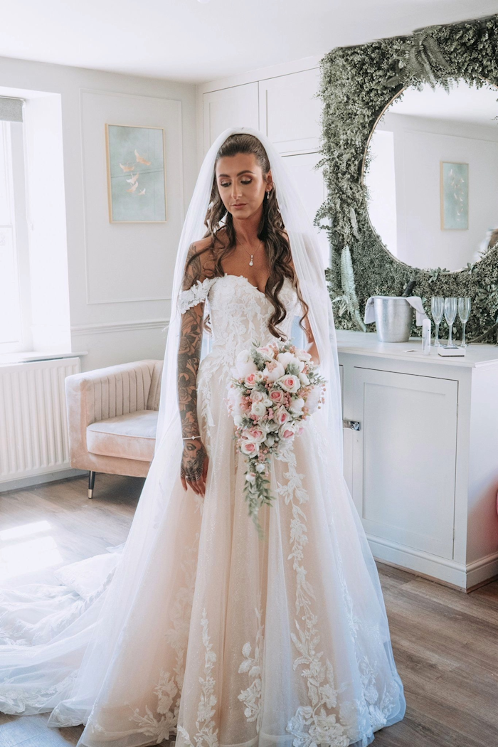 real life bride with her wedding bouquet of silk flowers created by the brides bouquet uk pink bridal flowers florists choice
