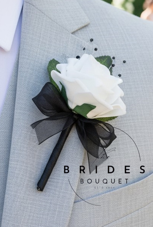 black and white themed wedding buttonholes black seed pearl and faux rose grooms