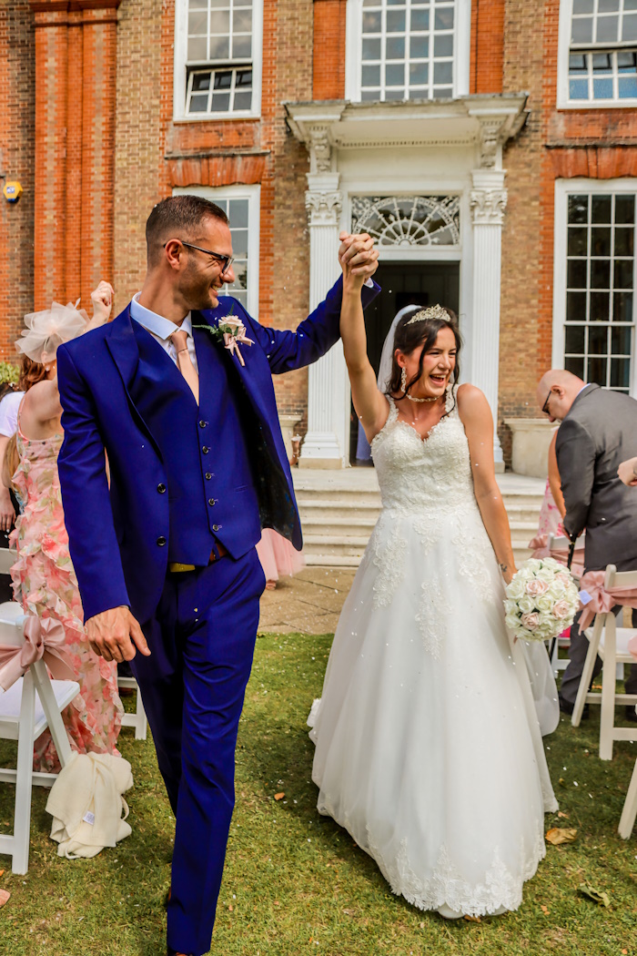 bride and groom real life wedding with rose gold and ivory rose bouquets by the brides bouquet uk