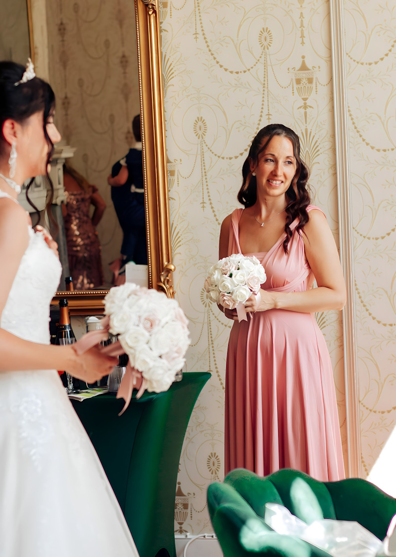 real life bride and bridesmaid with rose gold wedding flowers created by the brides bouquet uk