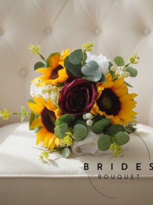 Silk rose sunflower and eucalyptus bridesmaid bouquet with gypsophila
