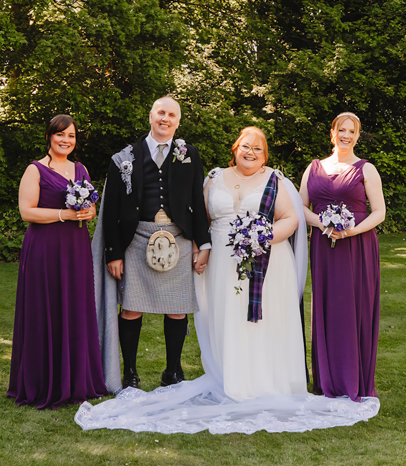 bride groom bridesmaids at scottish wedding with flowers thistles roses the brides bouquet uk