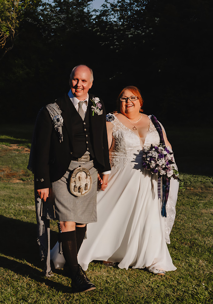 bride groom smiling with scottish bridal flowers artificial thistles roses real life wedding