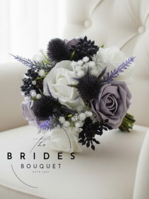 Purple thistle and heather flower girl posy with roses, gypsophila and berries