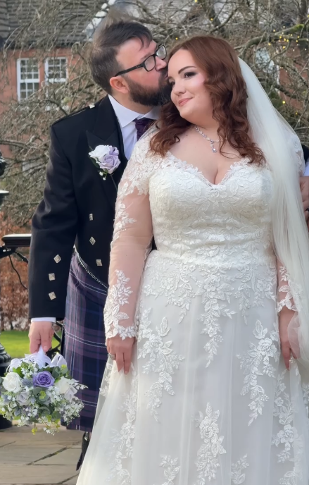real life wedding couple scottish tartan kilt with lilac bridal flowers by the brides bouquet uk