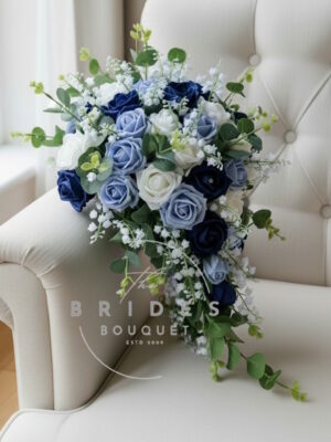 brides tear bouquet of artificial faux roses with lily of the valley and eucalyptus