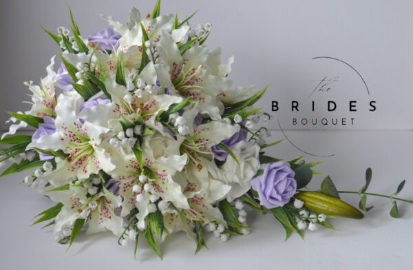 brides tear bouquet with roses tiger lily lily of the valley