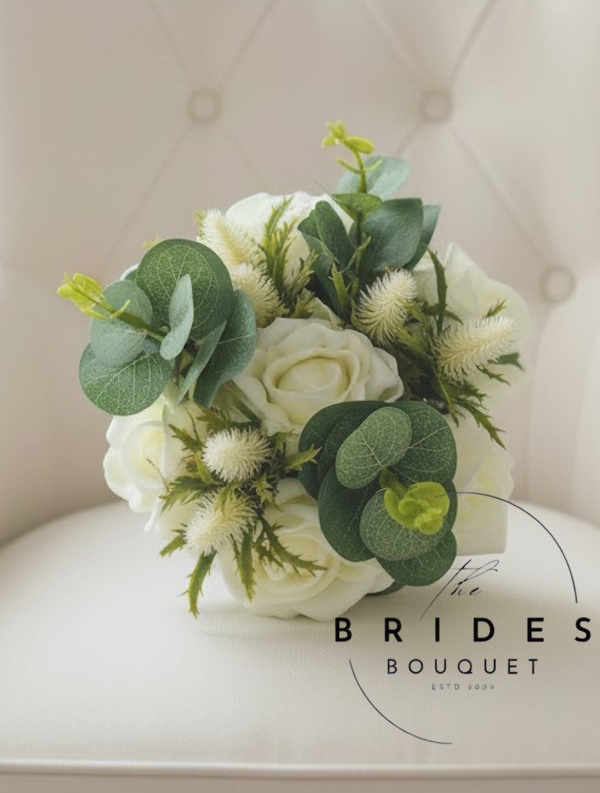 flower girl bouquet of ivory roses thistles and eucalyptus
