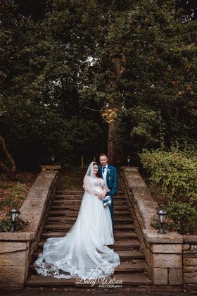 real life bride with artificial wedding flowers by the brides bouquet uk royal blue and silver rose posy