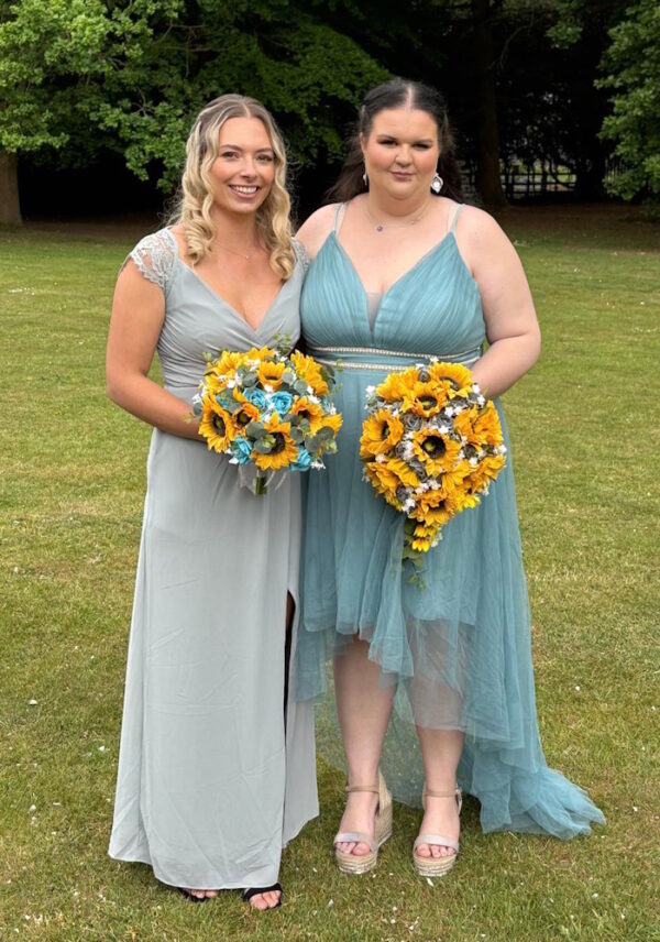 bride and bridesmaid with sunflower and rose bridal flowers