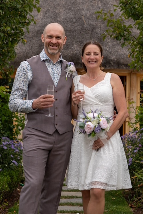 real life bride and groom with silk peony and heather bridal bouquet customers photo