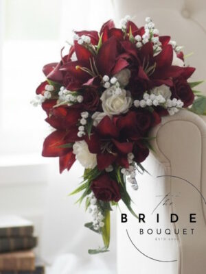 Handmade teardrop bouquet featuring silk tiger lilies, roses, and lily of the valley