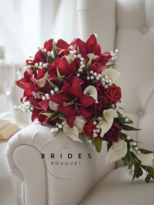 Handmade teardrop bouquet featuring silk tiger lilies, roses, and lily of the valley