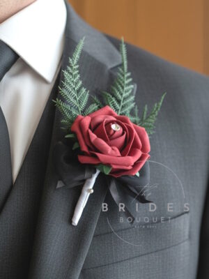 artificial rose wedding buttonhole corsage butgundy rose with white stem and black bow