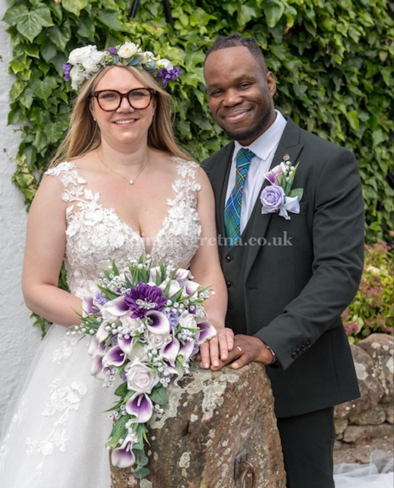beautiful-bride-and-groom-with-wedding-flowers-in-purple-created-by-the-brides-bouquet-uk