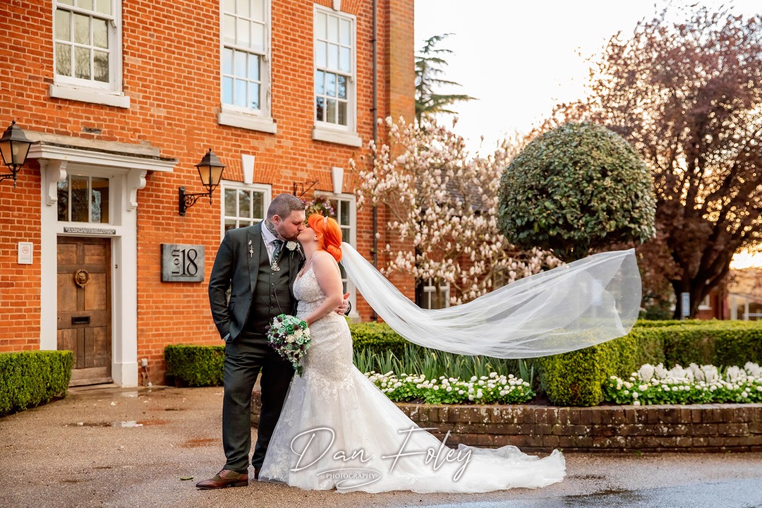 bride and groom with green themed wedding flowers by the brides bouquet uk