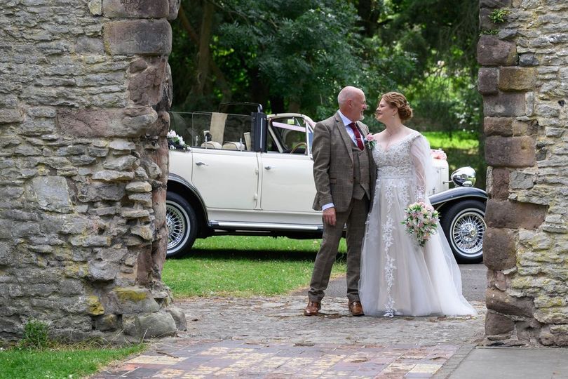 bride groom classic car with silk flowers created by the brides bouquet uk