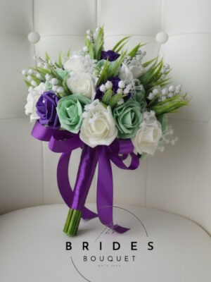 Artificial wedding bouquet with lily of the valley and roses