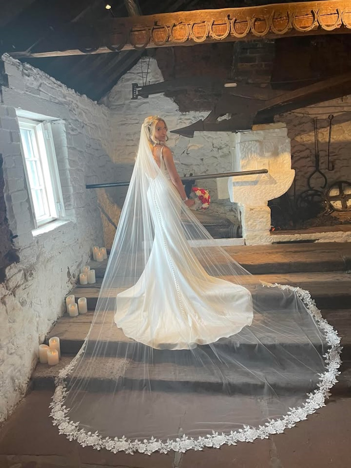 bride georgia on her wedding day at gretna green over the anvil with red silk bridal bouquet created by the brides bouquet uk