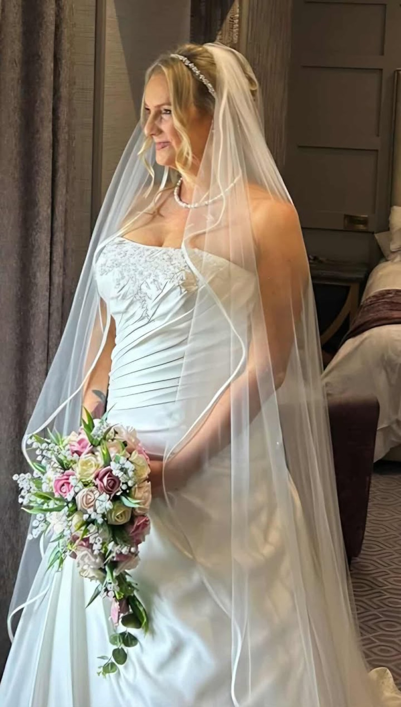 bride with wedding tear bouquet in pink and chamapgne roses with lily of the valley