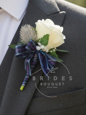 Custom colour Scottish rose and thistle wedding buttonhole with tartan ribbon, gypsophila and pearl pin