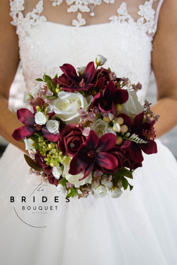 "Burgundy and ivory winter wedding bouquet with silk roses and magnolias"