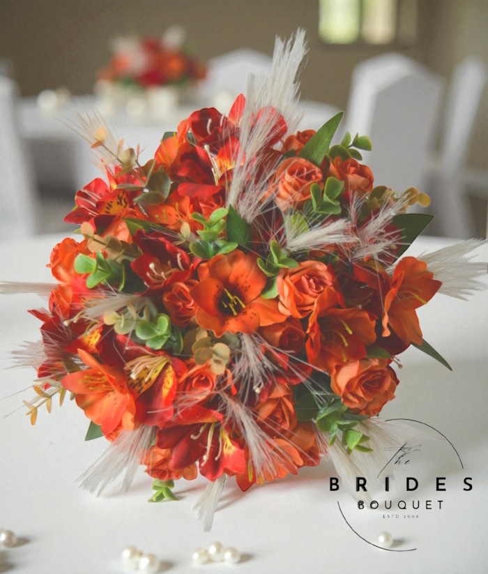 orange themed bridal bouquet with pampas and alstromeria