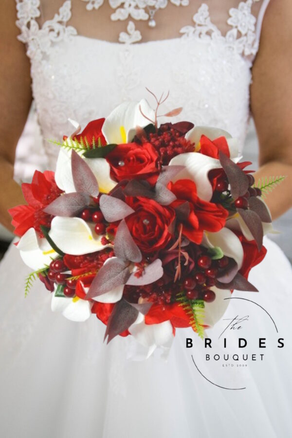 Winter wedding bouquet with red and burgundy silk roses, white calla lilies and poinsettias