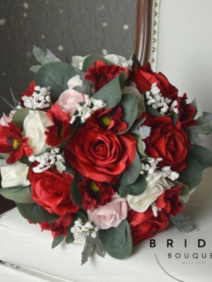 Red silk rose wedding bouquet with pink and ivory glitter accents, ribbon-wrapped handle