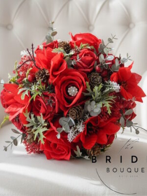 deep red winter wedding bouquet roses poinsettia foliage ready to ship