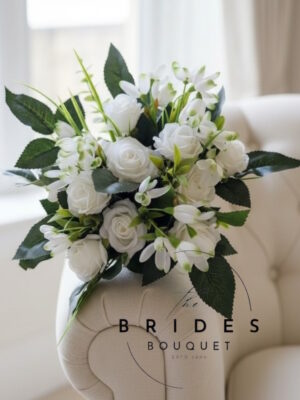 White winter wedding bouquet with white roses, snowdrops and matching buttonhole