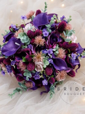 Amethyst purple and pink artificial bridal bouquet with calla lilies, roses, thistles and matching groom's buttonhole