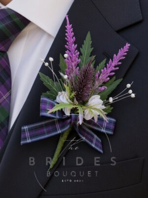Thistle and heather buttonhole with tartan ribbon bow in chosen colours